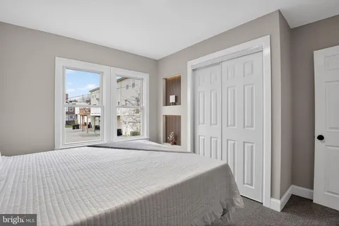 a bedroom with a large bed and a window