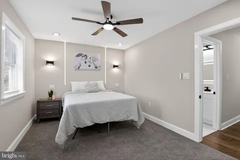 a spacious bedroom with a bed and a chandelier