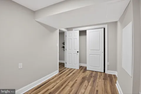 a view of a room with wooden floor