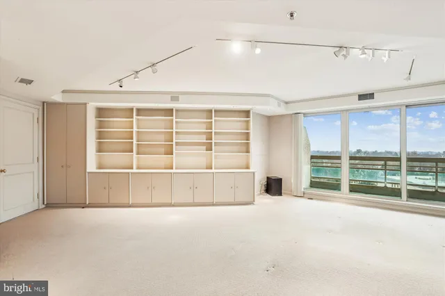 a kitchen with a sink appliances and cabinets