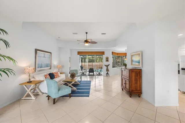 a living room with furniture and dining table
