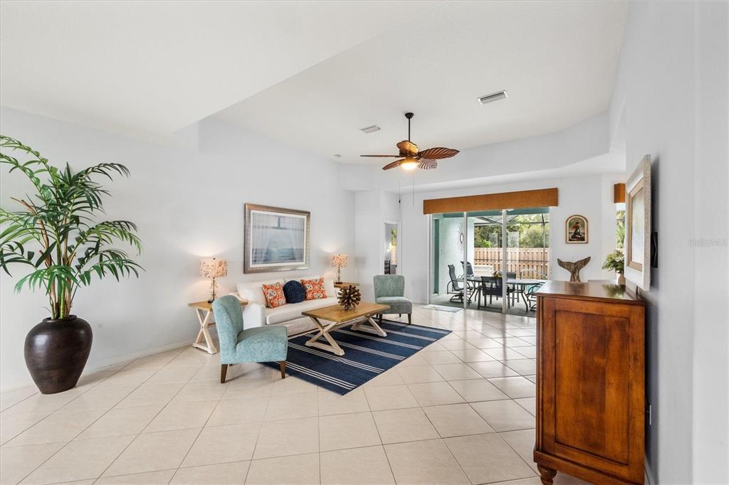 160 Wading Bird Drive Venice, FL 34292 - Photo 14 of 47 a living room with furniture a large window and a potted plant