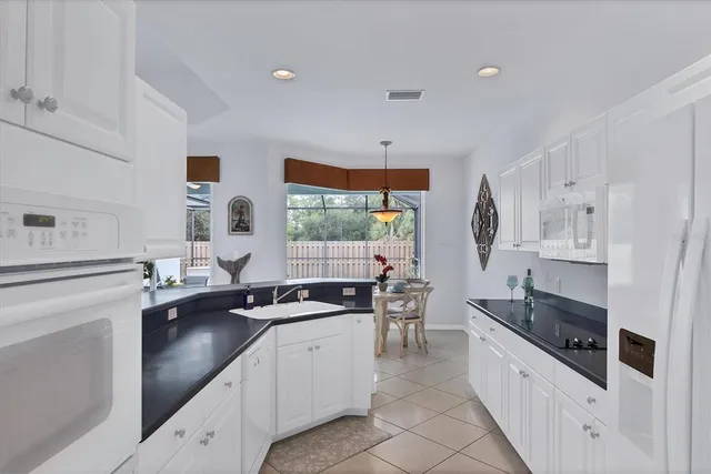 a kitchen with stainless steel appliances a sink stove and cabinets