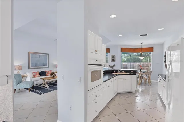a kitchen with white cabinets and white appliances