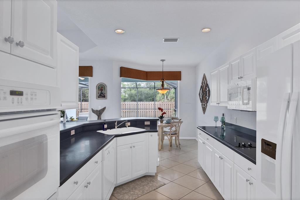 160 Wading Bird Drive Venice, FL 34292 - Photo 23 of 47 a kitchen with stainless steel appliances a sink stove and cabinets