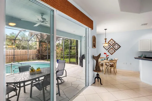 a dining room with furniture and a floor to ceiling window