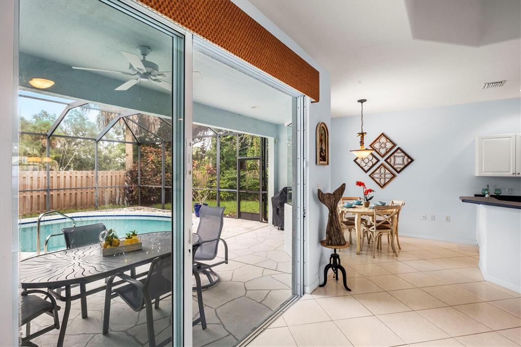 160 Wading Bird Drive Venice, FL 34292 - Photo 26 of 47 a dining room with furniture and a floor to ceiling window