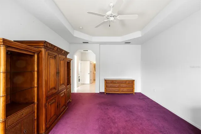 an empty room with windows and cabinet