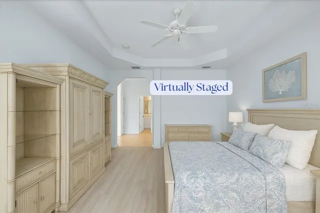 a spacious bedroom with a bed and a chandelier