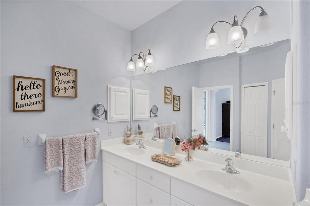 160 Wading Bird Drive Venice, FL 34292 - Photo 36 of 47 a bathroom with a sink and a mirror