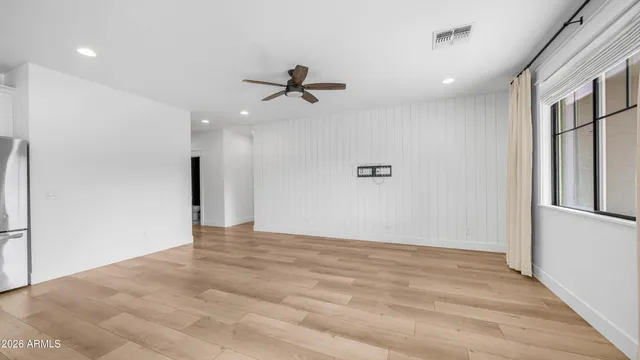 a kitchen with white cabinets and appliances