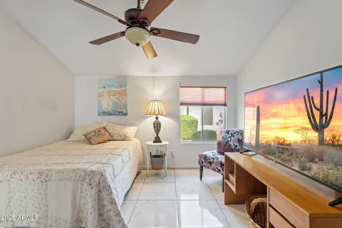 a bedroom with a bed and a large window