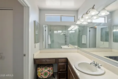 a bathroom with a sink a mirror and a shower
