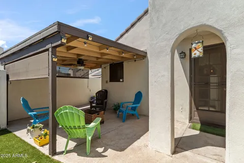 a view of two chairs in patio of the house