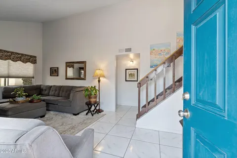 a living room with furniture and stairs