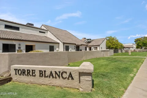 a view of a swimming pool with an buildings in the background