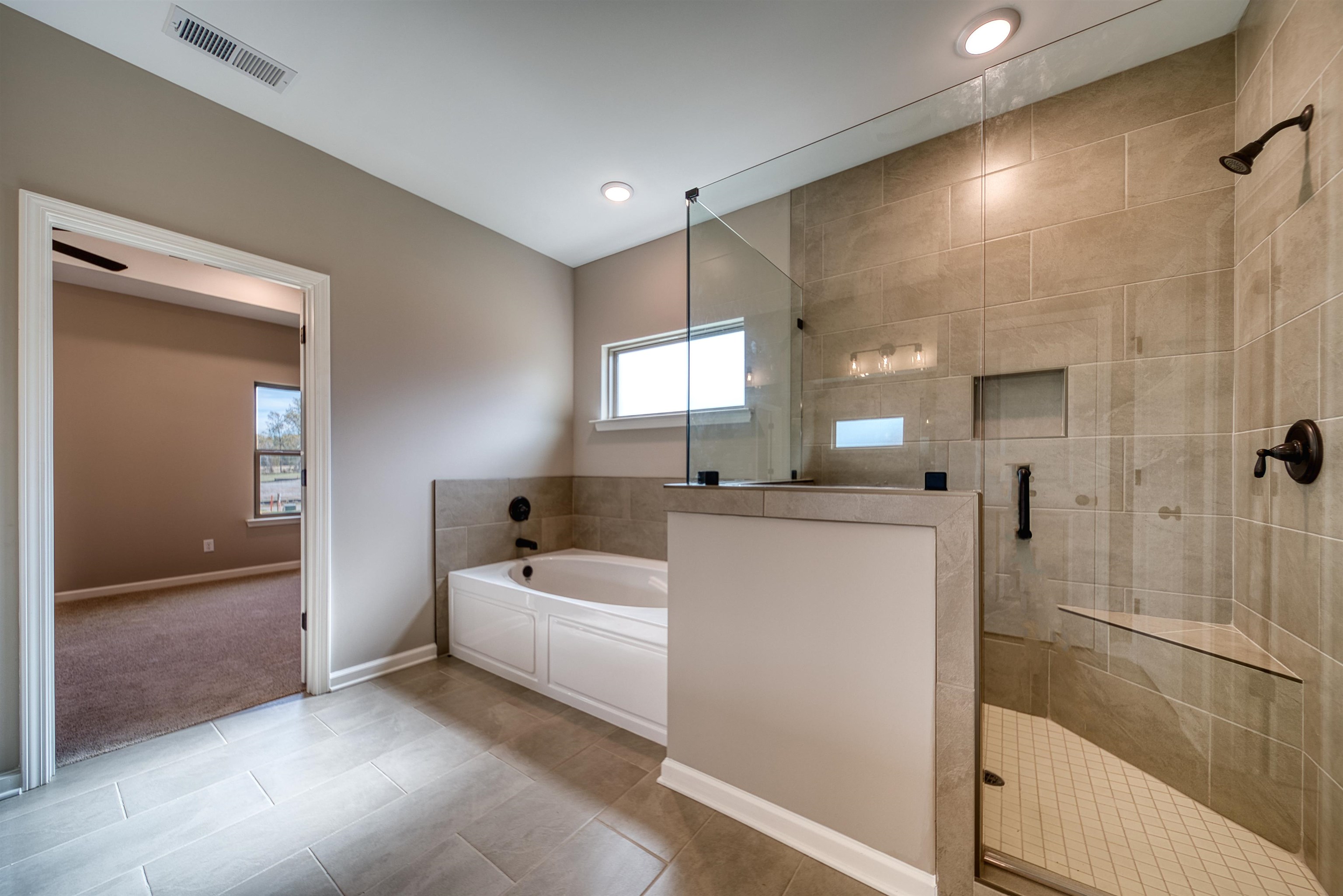 515 Garland Drive Covington, TN 38019 - Photo 23 of 38 Full bathroom with a garden tub, a stall shower, and light tile patterned floors