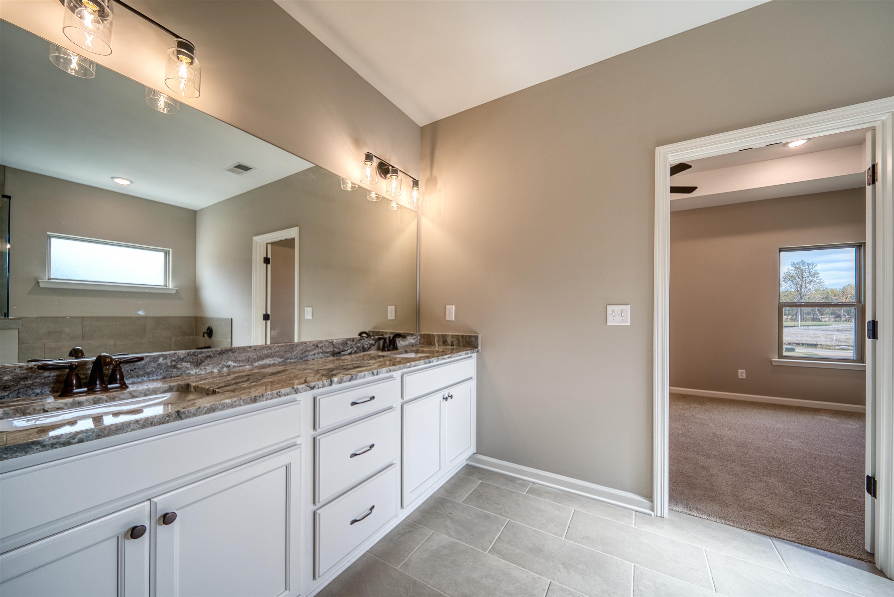 515 Garland Drive Covington, TN 38019 - Photo 25 of 38 a spacious bathroom with a granite countertop sink mirror and double