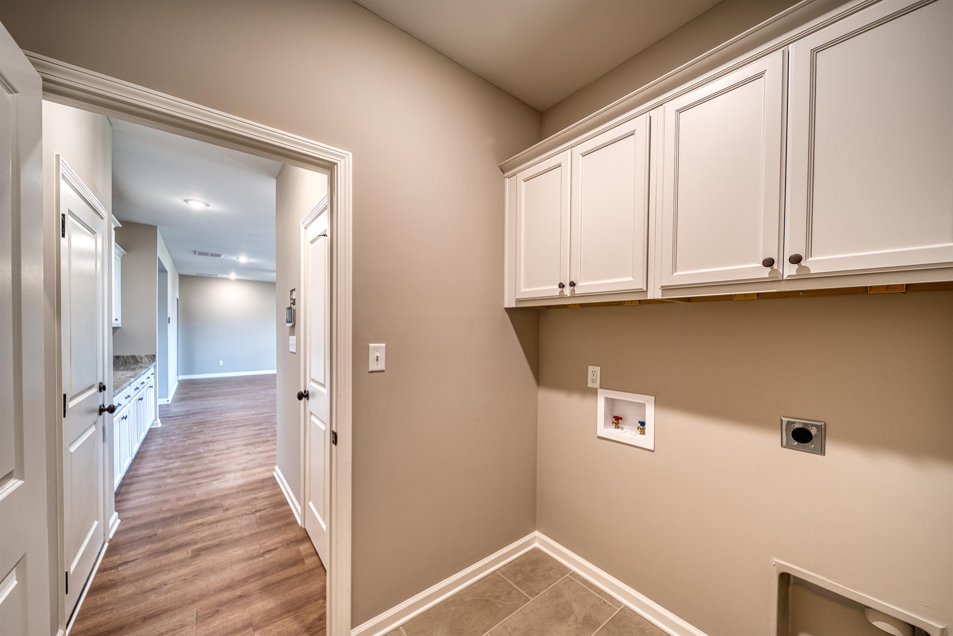 515 Garland Drive Covington, TN 38019 - Photo 28 of 38 a view of a hallway with wooden floor and staircase