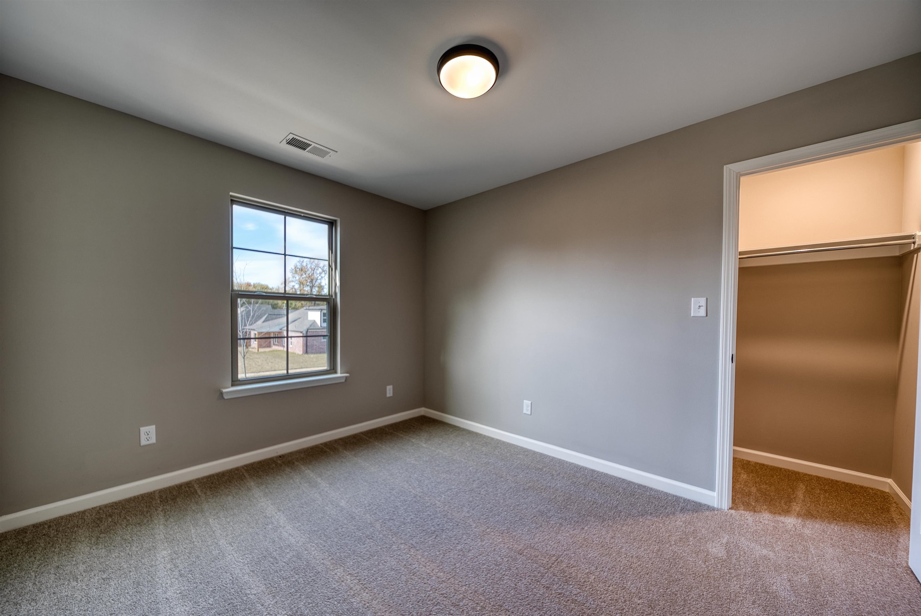 515 Garland Drive Covington, TN 38019 - Photo 37 of 38 an empty room with windows and closet