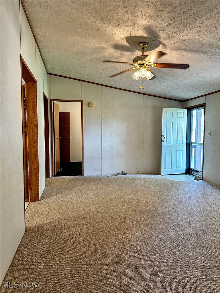 347 Brownville Road Rome, OH 44085 - Photo 13 of 36 Unfurnished room with a textured ceiling, ceiling fan, and carpet flooring