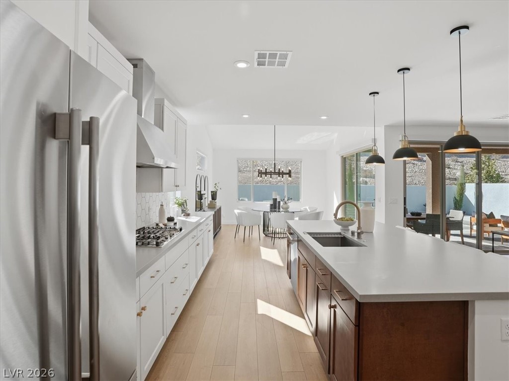 9725 Starlight Ridge Avenue Las Vegas, NV 89148 - Photo 18 of 47 This spacious kitchen offers a seamless blend of style and functionality, perfect for culinary adventures.