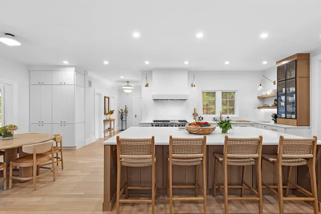 a dining room with stainless steel appliances kitchen island granite countertop a dining table chairs and view kitchen
