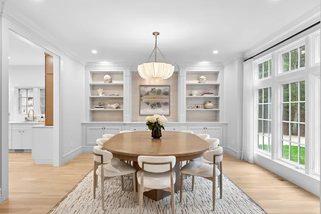 a dining room with furniture window and wooden floor