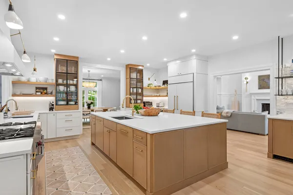 a large kitchen with stainless steel appliances a stove a sink dishwasher and a refrigerator