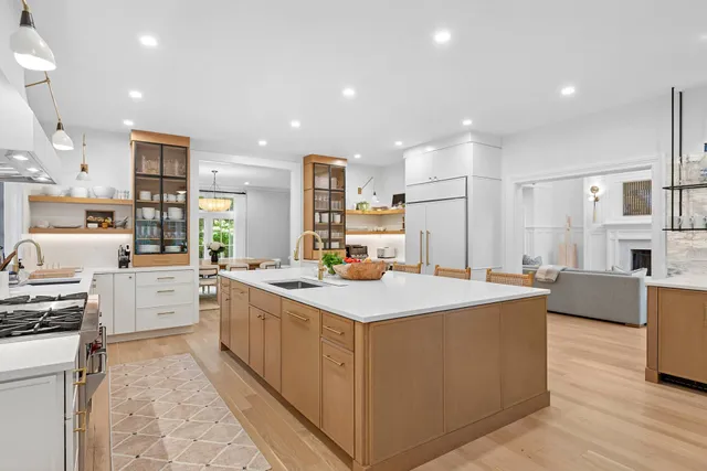 a large kitchen with stainless steel appliances a stove a sink dishwasher and a refrigerator