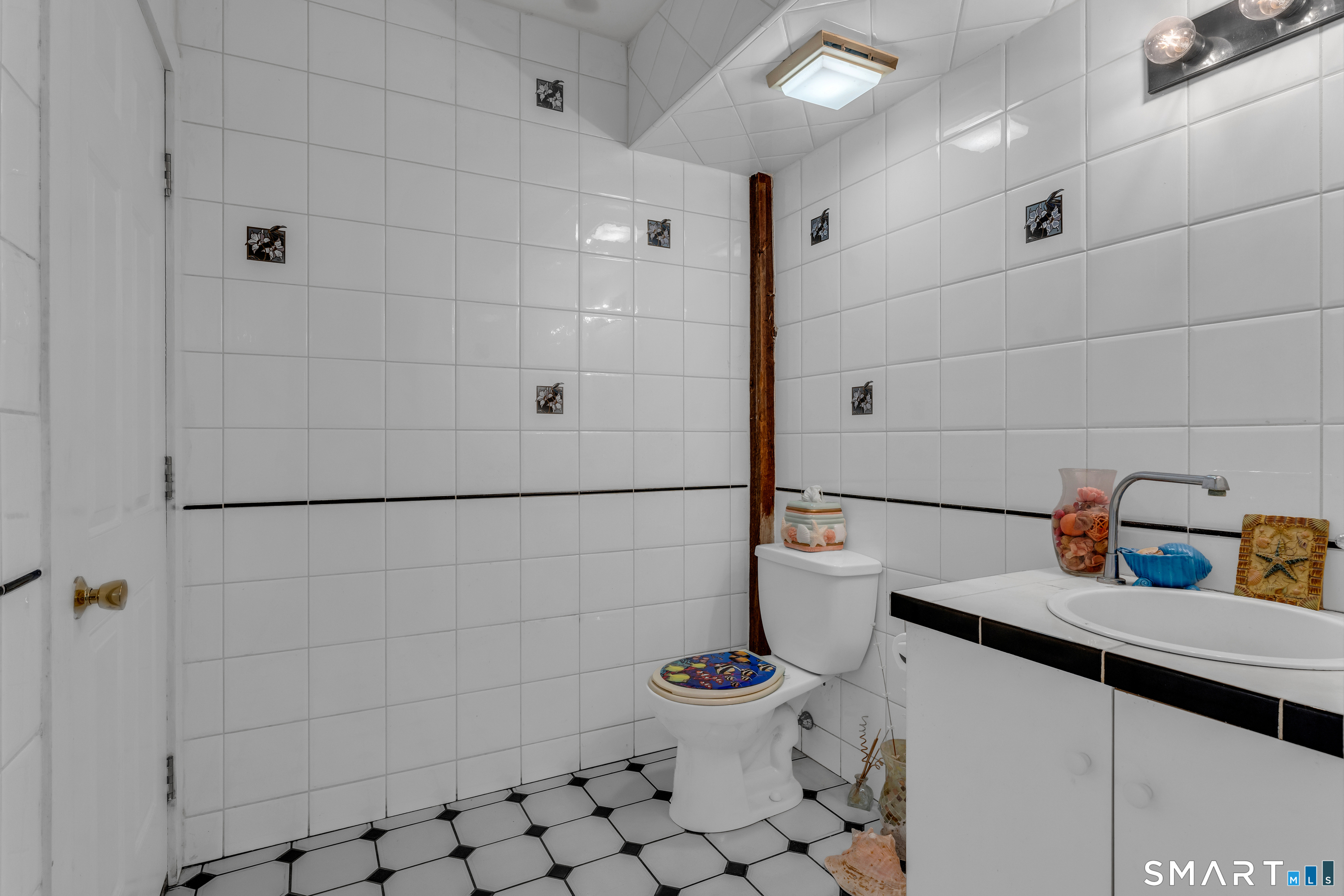 51 Mill Road Guilford, CT 06437 - Photo 9 of 30 a bathroom with a sink toilet and shower