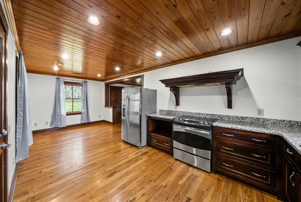 a bathroom with a granite countertop sink a toilet and shower