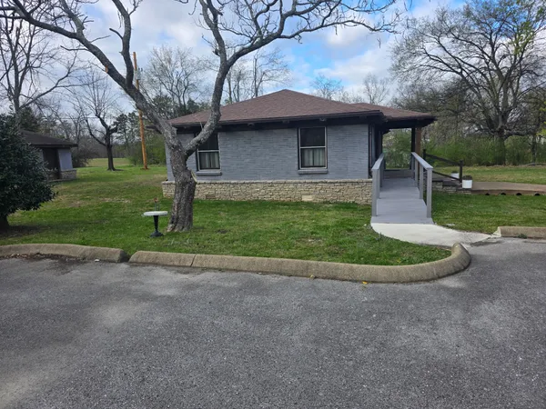 a view of a house with backyard porch and sitting area