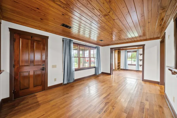 a view of a hall with wooden floor