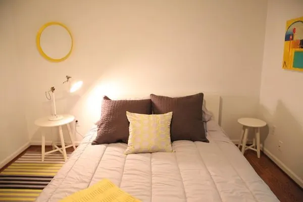 a lamp on a table and chair in a room