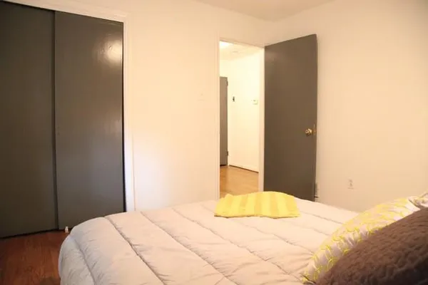 a bedroom with a bed and a mirror