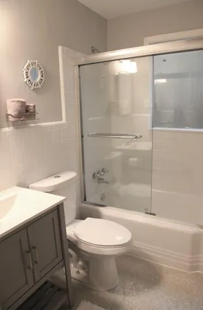 a bathroom with a toilet a sink and shower
