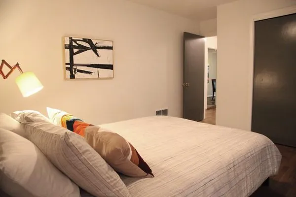 a bedroom with a bed and cupboard