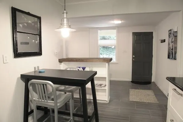 a dining room with furniture and window