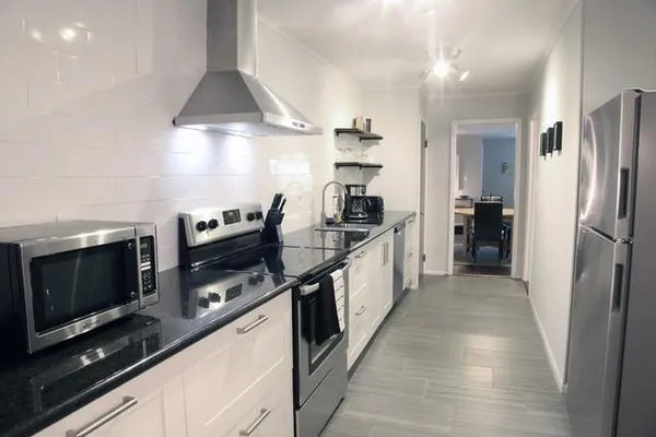 a kitchen with stainless steel appliances a stove and a refrigerator