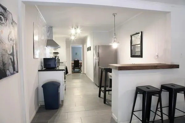 a view of a kitchen with furniture and a refrigerator
