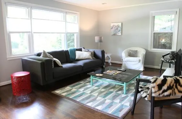 a living room with furniture and wooden floor