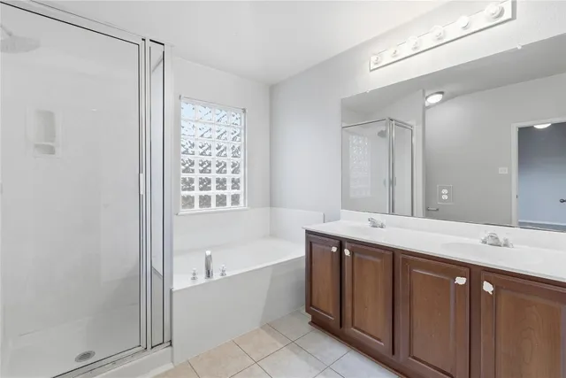 a bathroom with a tub sink and mirror