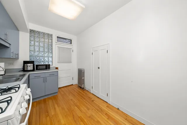 a kitchen with a stove and white cabinets