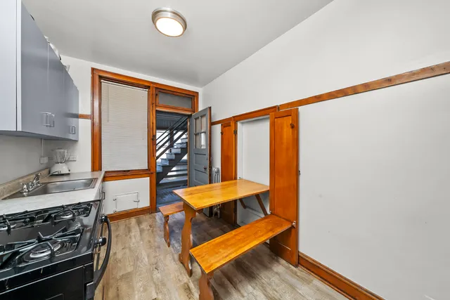 a room with wooden floor and furniture