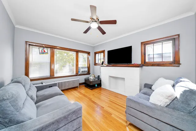 a living room with furniture flat screen tv and a large window