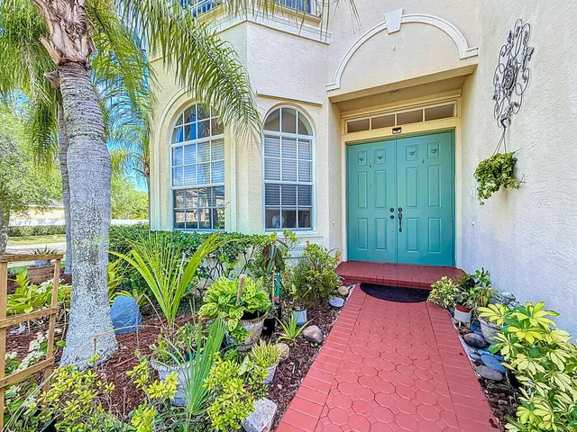 a living room with furniture a large window and a flat screen tv