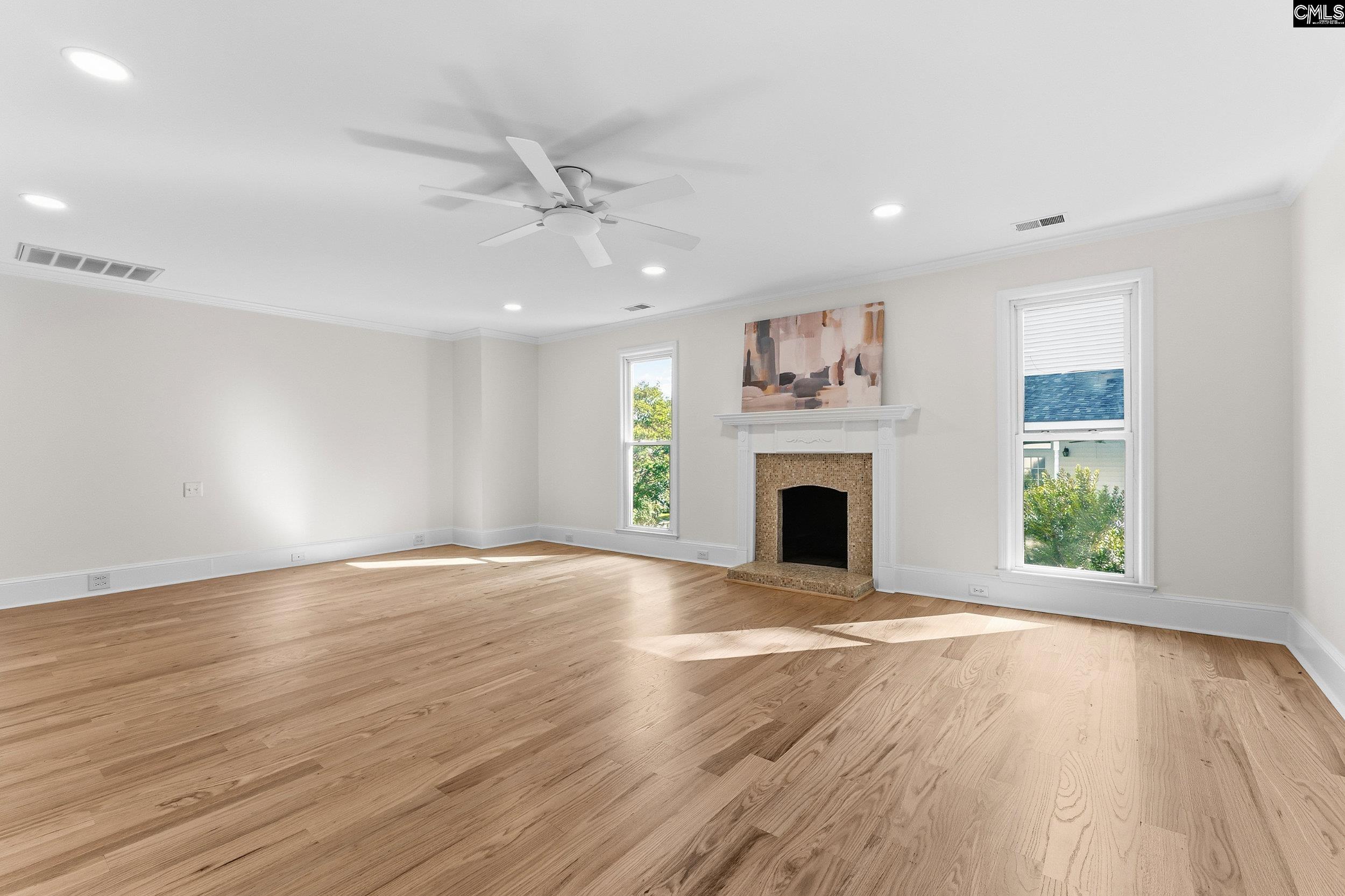 121 Silver Lake Road East Columbia, SC 29223 - Photo 34 of 57 a view of a livingroom with a fireplace a ceiling fan and windows
