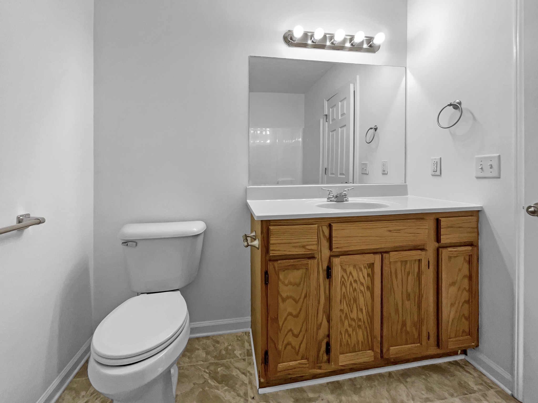 2284 Wiley Pardue Road Ashland City, TN 37015 - Photo 13 of 19 a bathroom with a granite countertop toilet a sink and a mirror