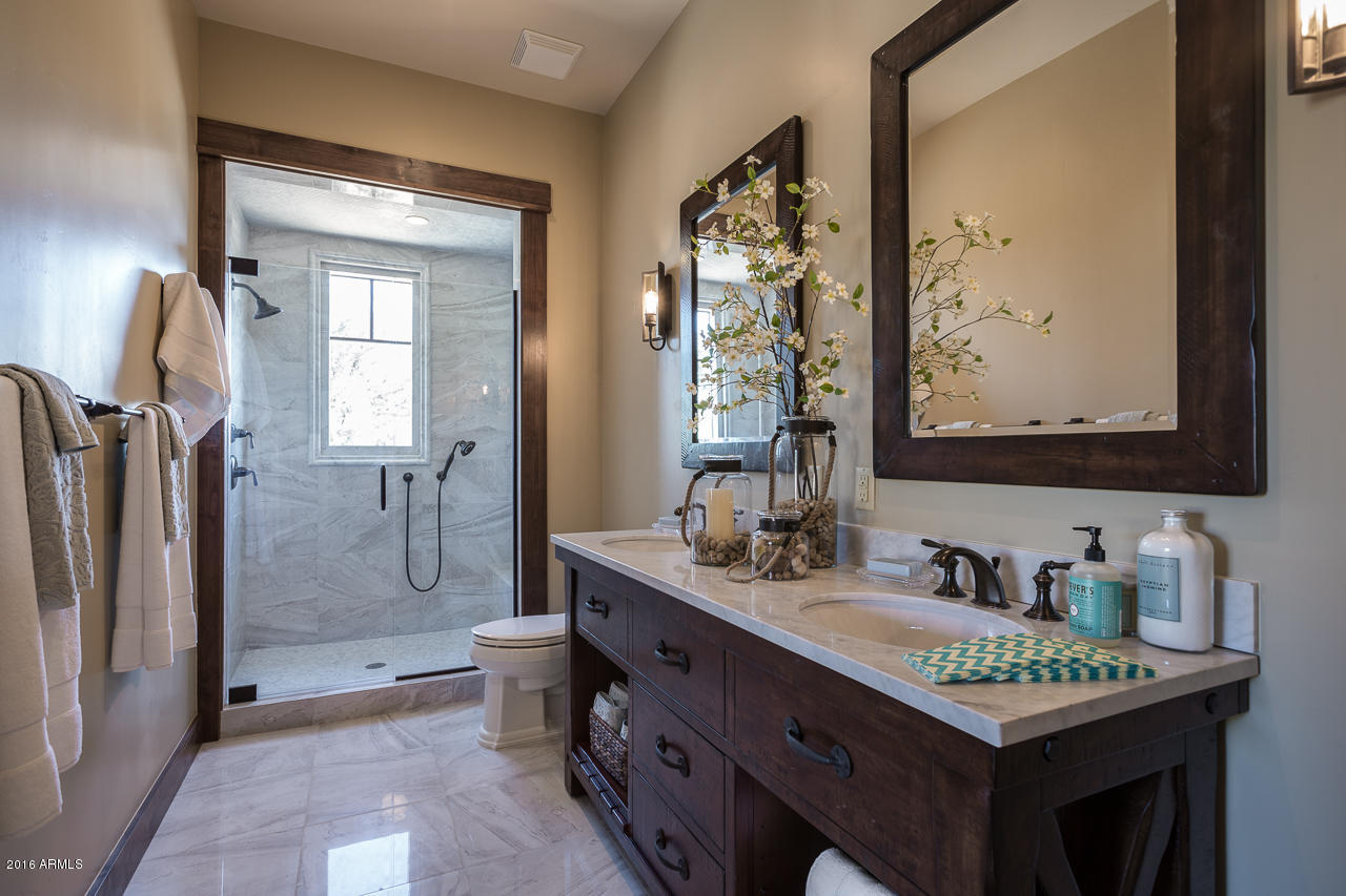 3003 East Arrow Point Payson, AZ 85541 - Photo 13 of 36 a bathroom with a granite countertop sink a toilet a mirror and shower